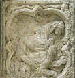 Panel 15:01 - Crouching figure (badly eroded)